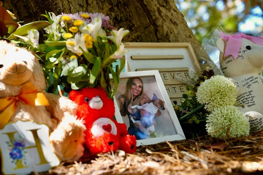 A memorial for Hailee with flowers and teddy bears.