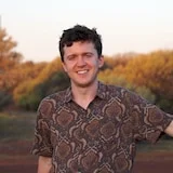 A man in a colourful shirt in a park