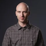 A journalist wearing a serious expression.