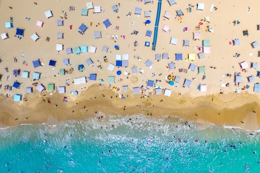 A birds-eye view of Noosa main beach full of beach cabanas.