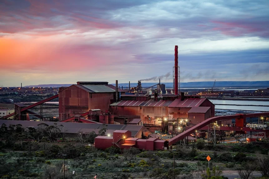 An industrial site next to the ocean.