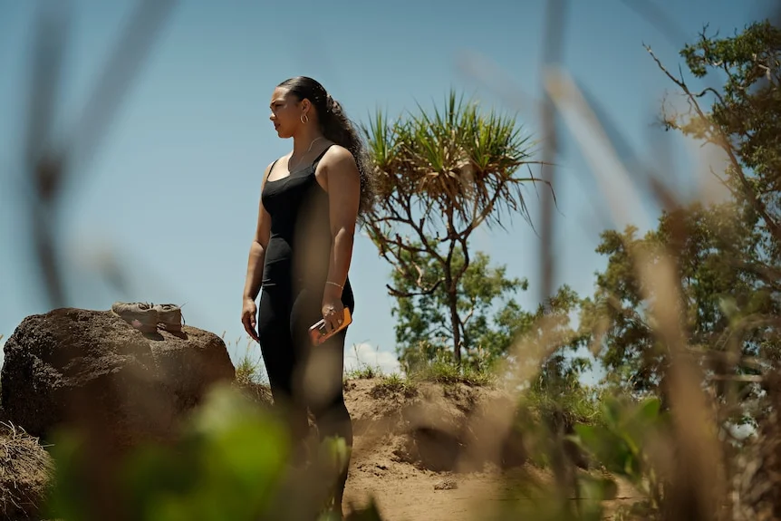 Woman standing on a beach.
