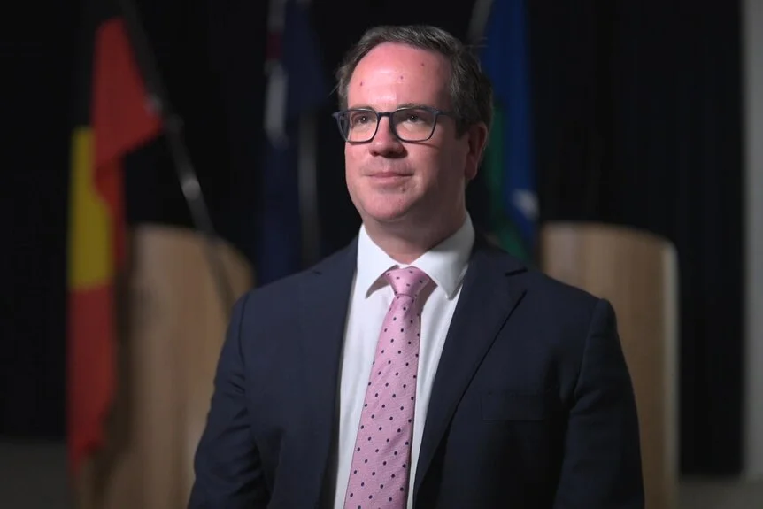 A man wearing a suit and pink tie