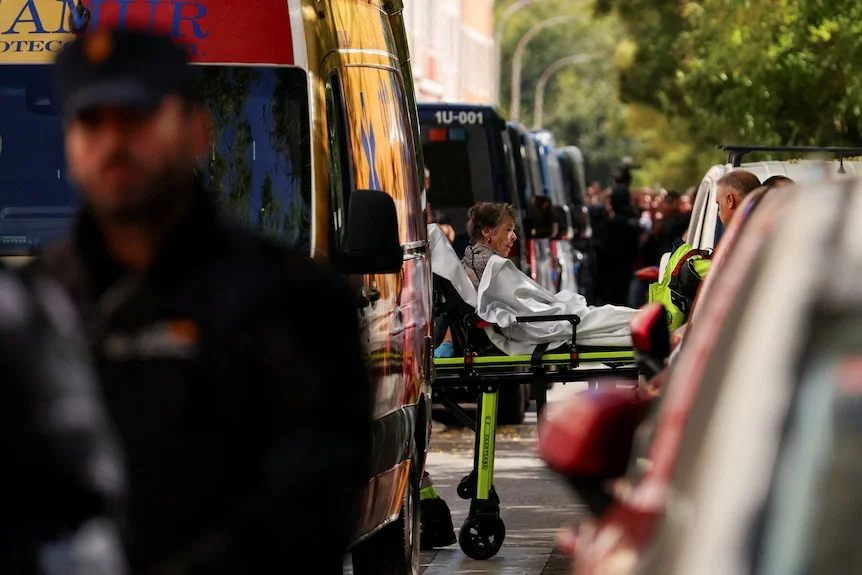 Maricarmen Abascal being taken out of her apartment on a stretcher.