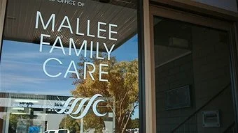 A sign on a window reading Mallee Family Care