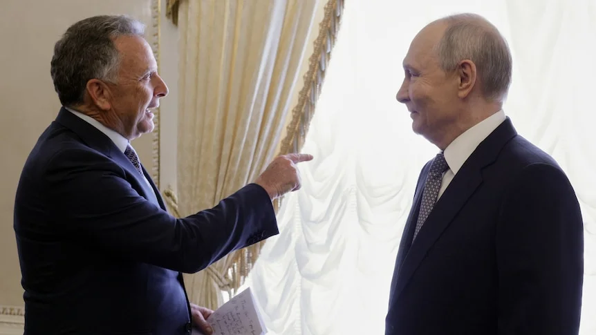 Steve Witkoff, left, is speaking and pointing his right finger, as he meets Vladimir Putin.