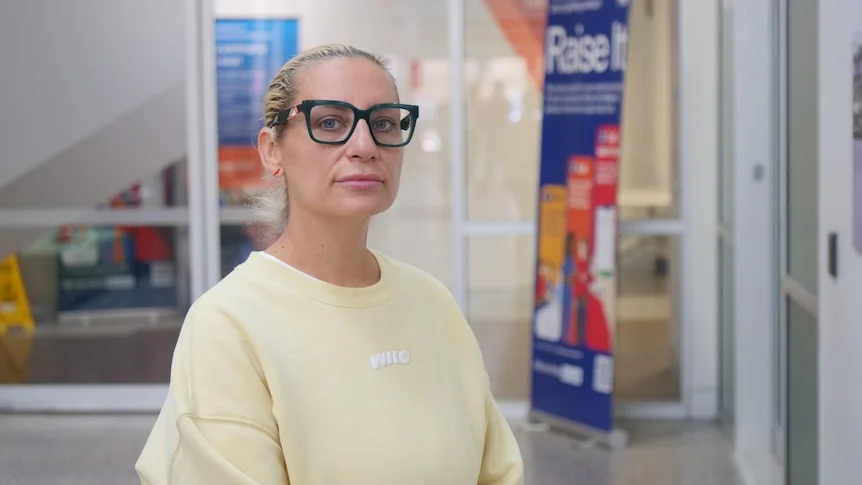 image of woman in glasses standing in hospital