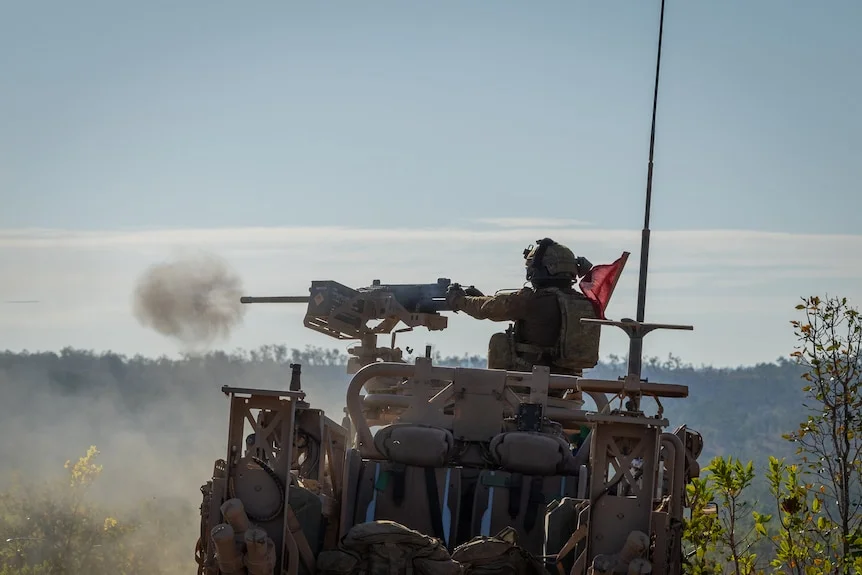 An Australian Army soldier fires from a High Mobility Transporter Supacat.