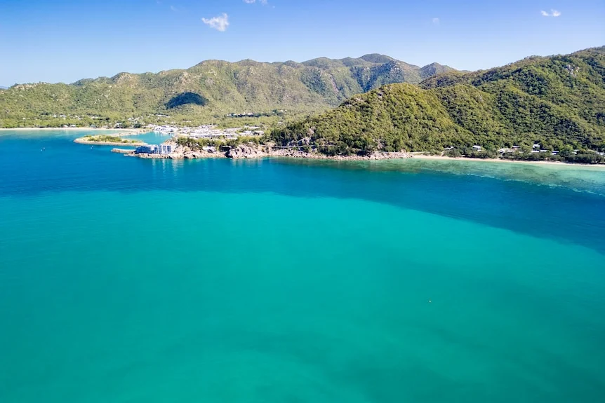 A July 2025 drone image of muddy water off the coast of an island.