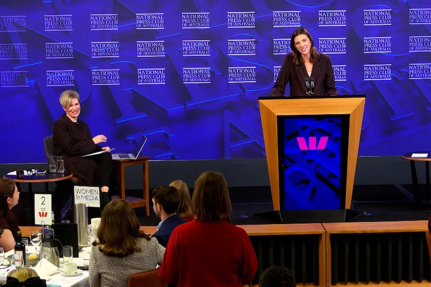 A late twenties woman addresses the National Press club, annoucing her plans to run for the Senate.