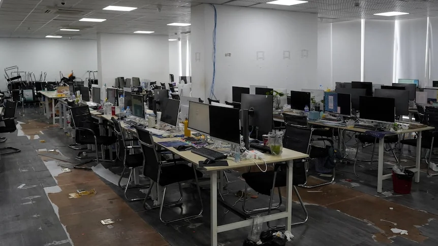 Rows of desks with computers and workstations.