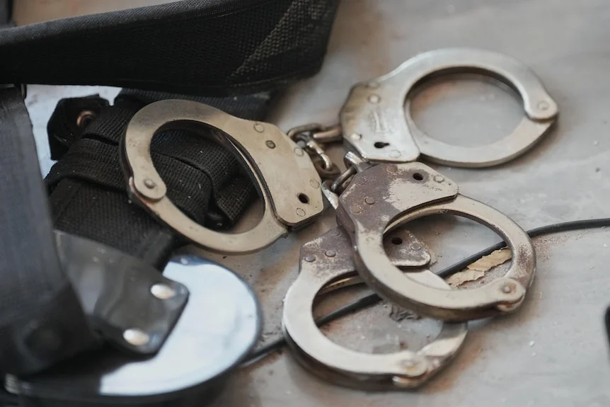 Two sets of handcuffs. 