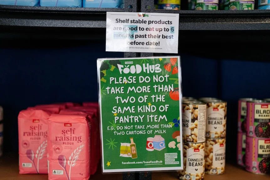 Flour, bean mix cans and signage on the shelf in a mini grocery store