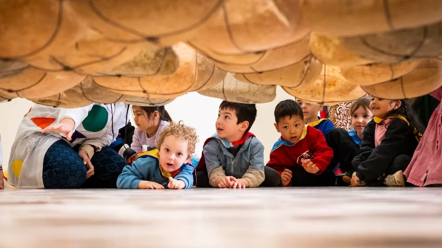 preschool students at Art Gallery of NSW wearing super hereo capes and surrounded by art