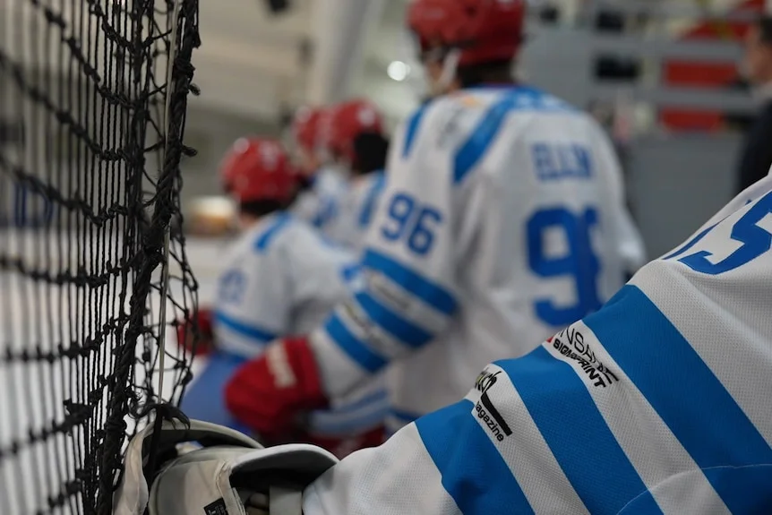 Close up shot of the back of ice hockey players 