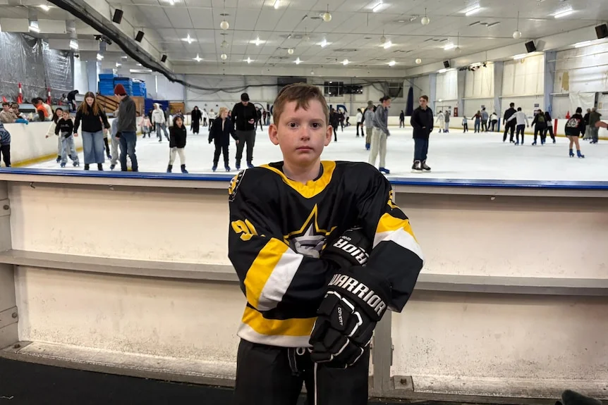 Nathaniel Coombes standing in front of an ice rink. 