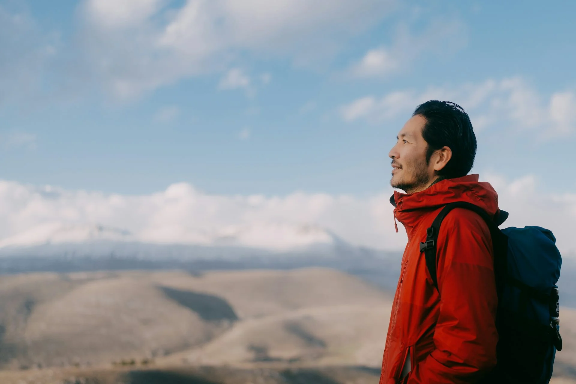 A man stands atop a mountain.