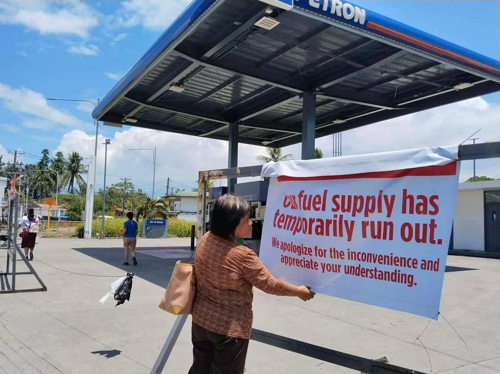 A passerby reads a sign stating that a petrol station in Tacloban City, the Philippines, is out of fuel amid the US-Israel war on Iran in March. Photo: AFP