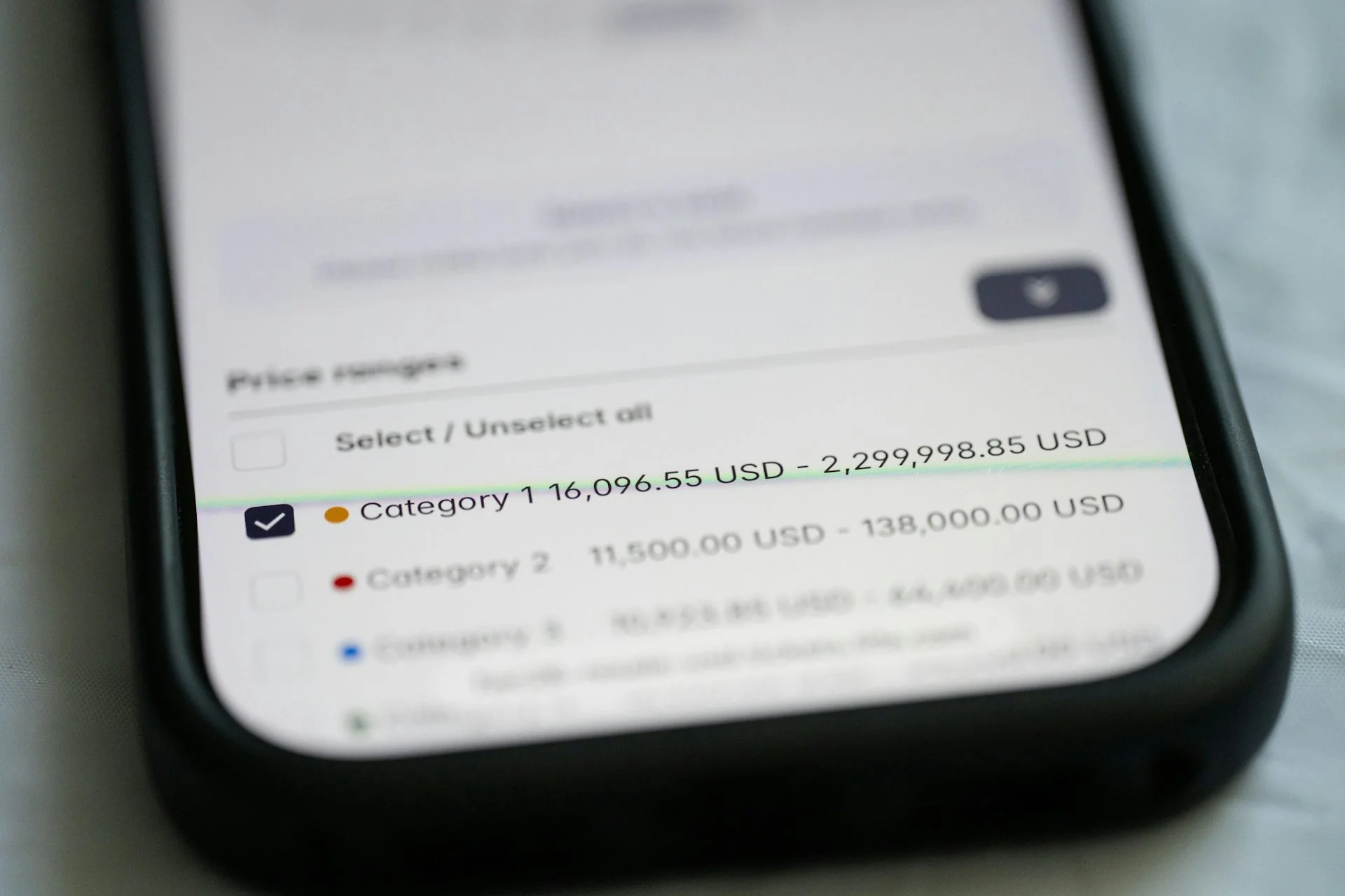 A phone screen shows some dollar figures.