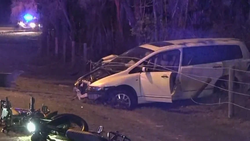 the wreckage of a crash between a mini van and two electric bikes