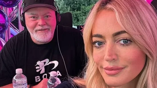 A selfie of Jackie O Henderson smiling with Kyle Sandilands in the background wearing radio headphones.