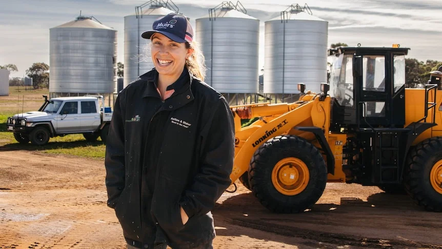 a female standing in front of a tractor in the Great Southern of WA.