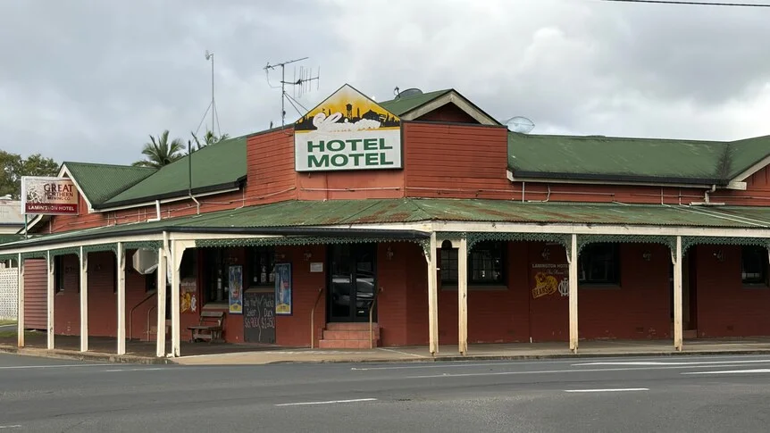 Medium-sized brick building with sign reading 'Lamington Hotel Motel'.