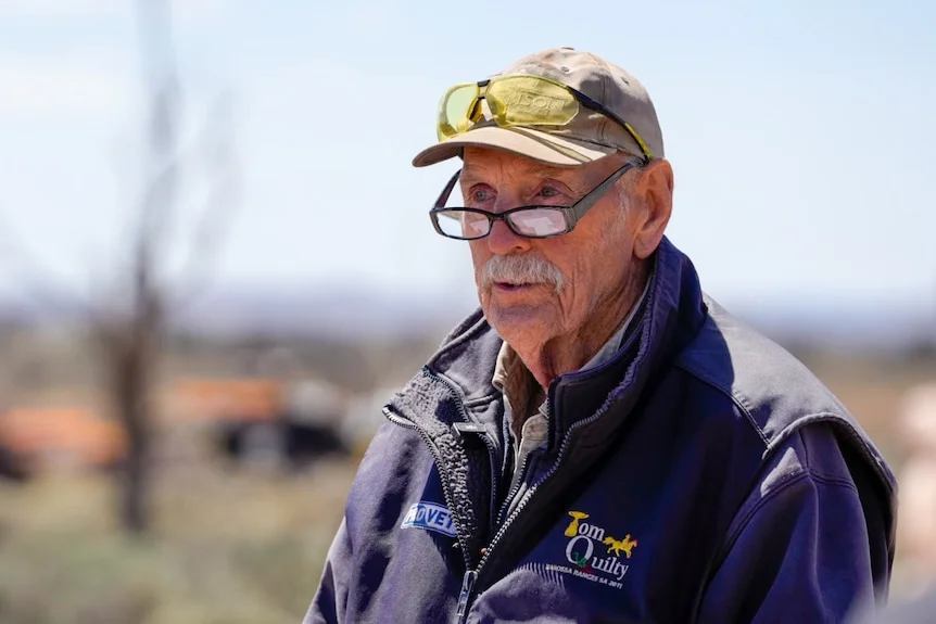 A man in a cap and glasses.