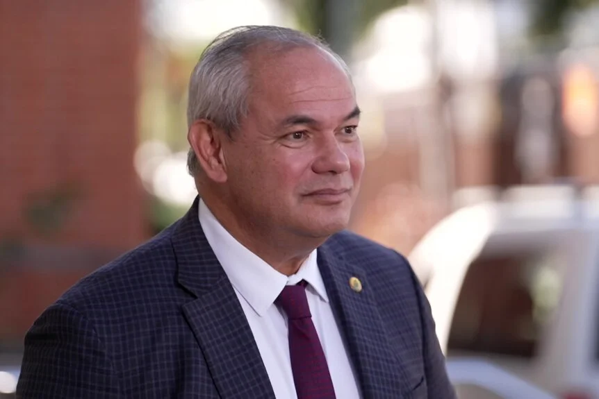 Man in suit looks off to the side