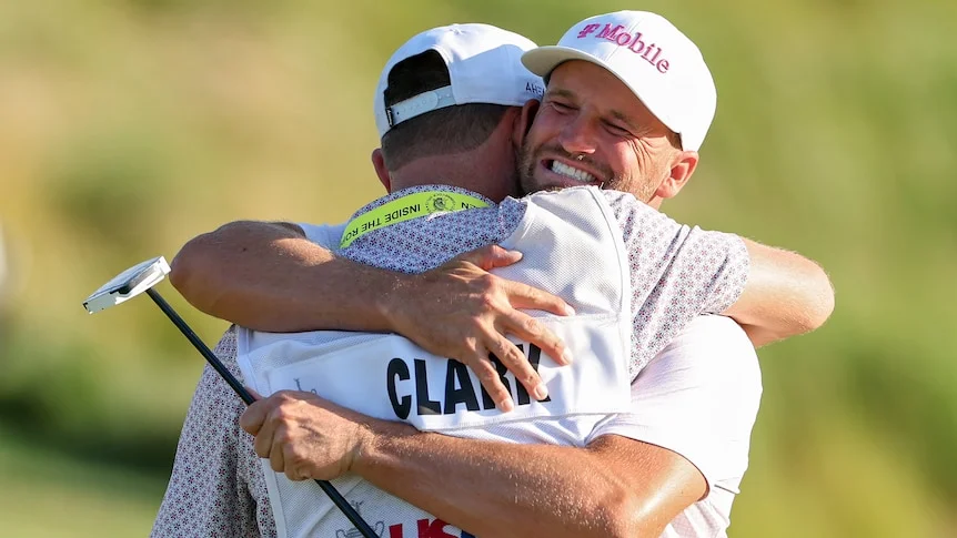 Wyndham Clark celebrates with caddie David Pelekoudas after winning US Open.