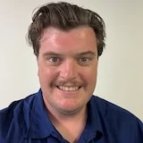 A man looking at the camera in a blue shirt