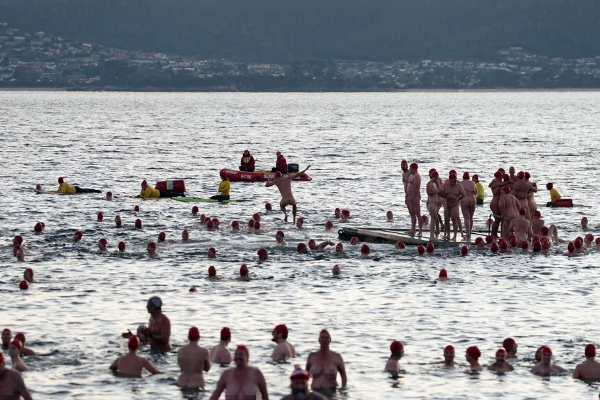 Naked swimmers in the River Derwent water celebrate the end of the longest night of the year for Nude Solstice Swim