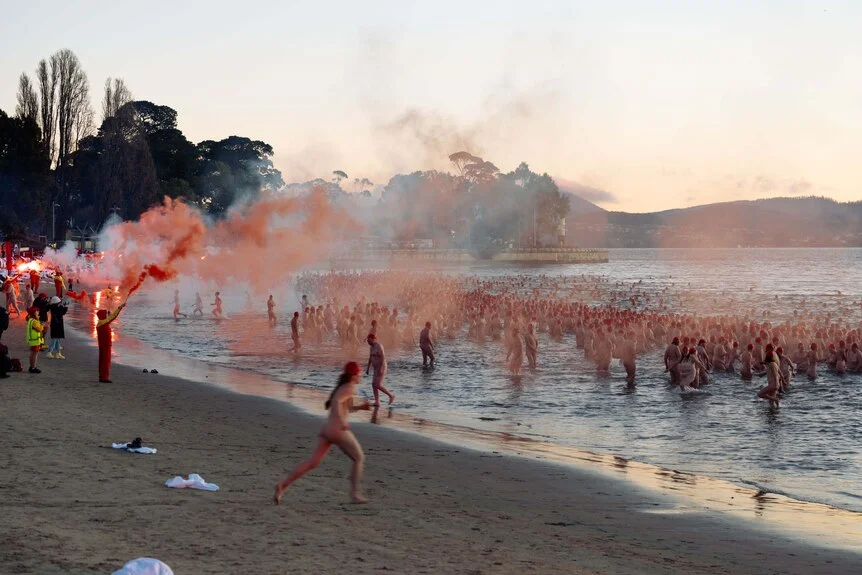 Naked swimmers take to the water for the 2026 Dark Mofo Nude Solstice Swim