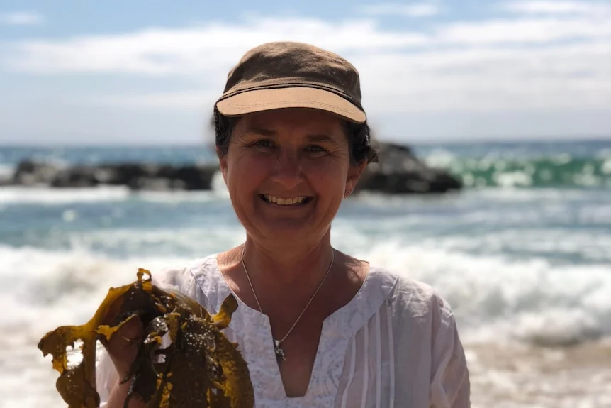 A women with kelp on beach