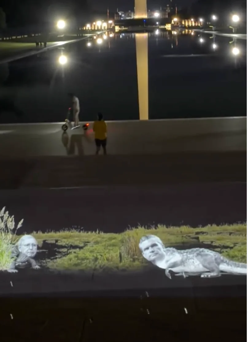 Projections across Washington DC from prankster group VJayBombs portrayed Senator Mitch McConnell and Defense Secretary Pete Hegseth as swamp creatures near the Lincoln Memorial Reflecting Pool