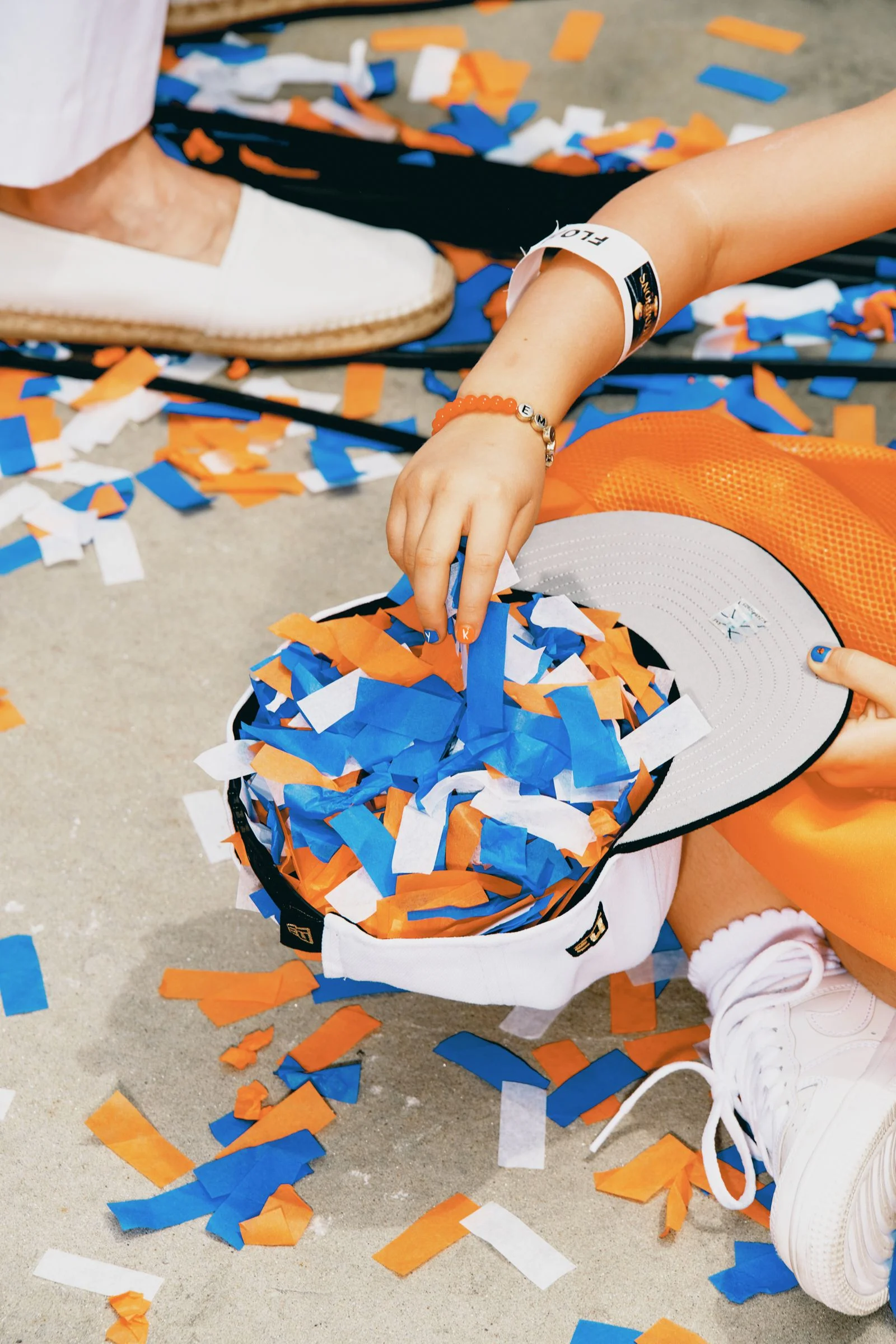 Figures hold confetti in hat