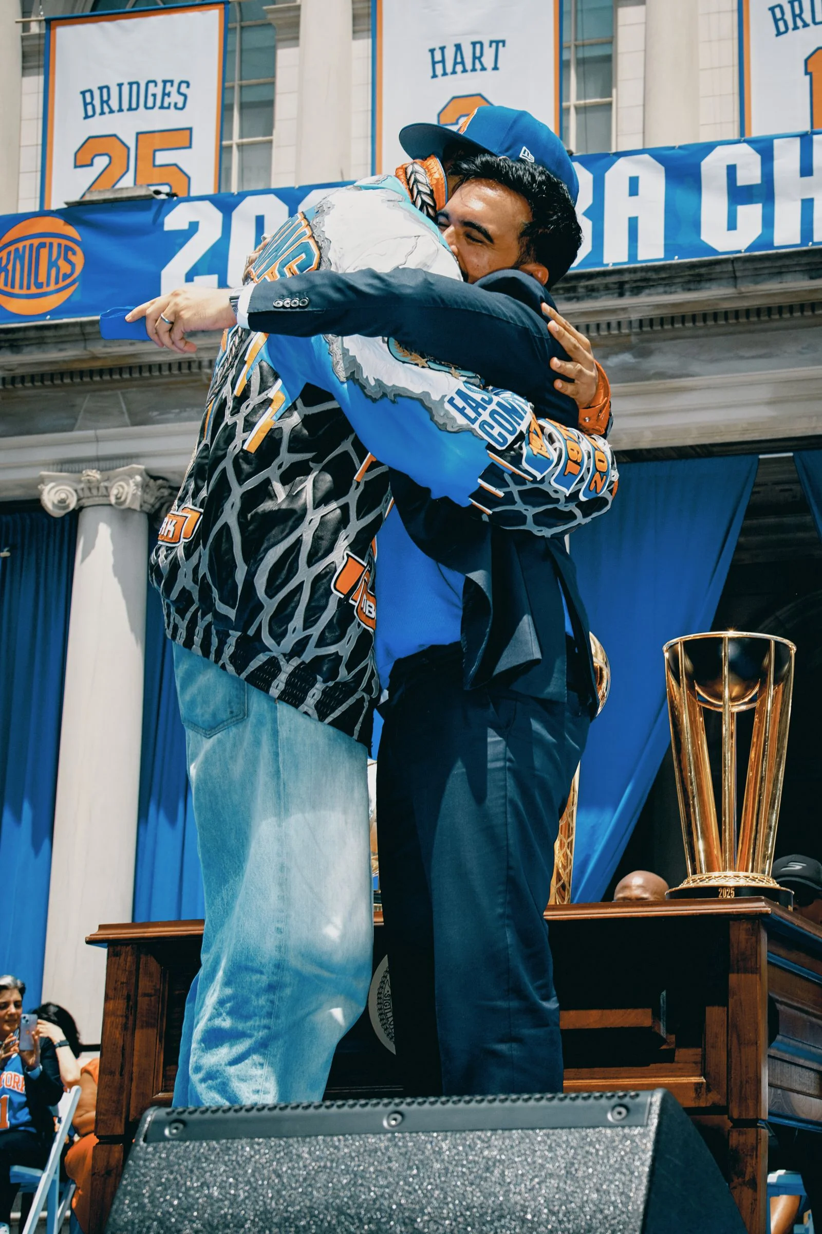 Two figures hug