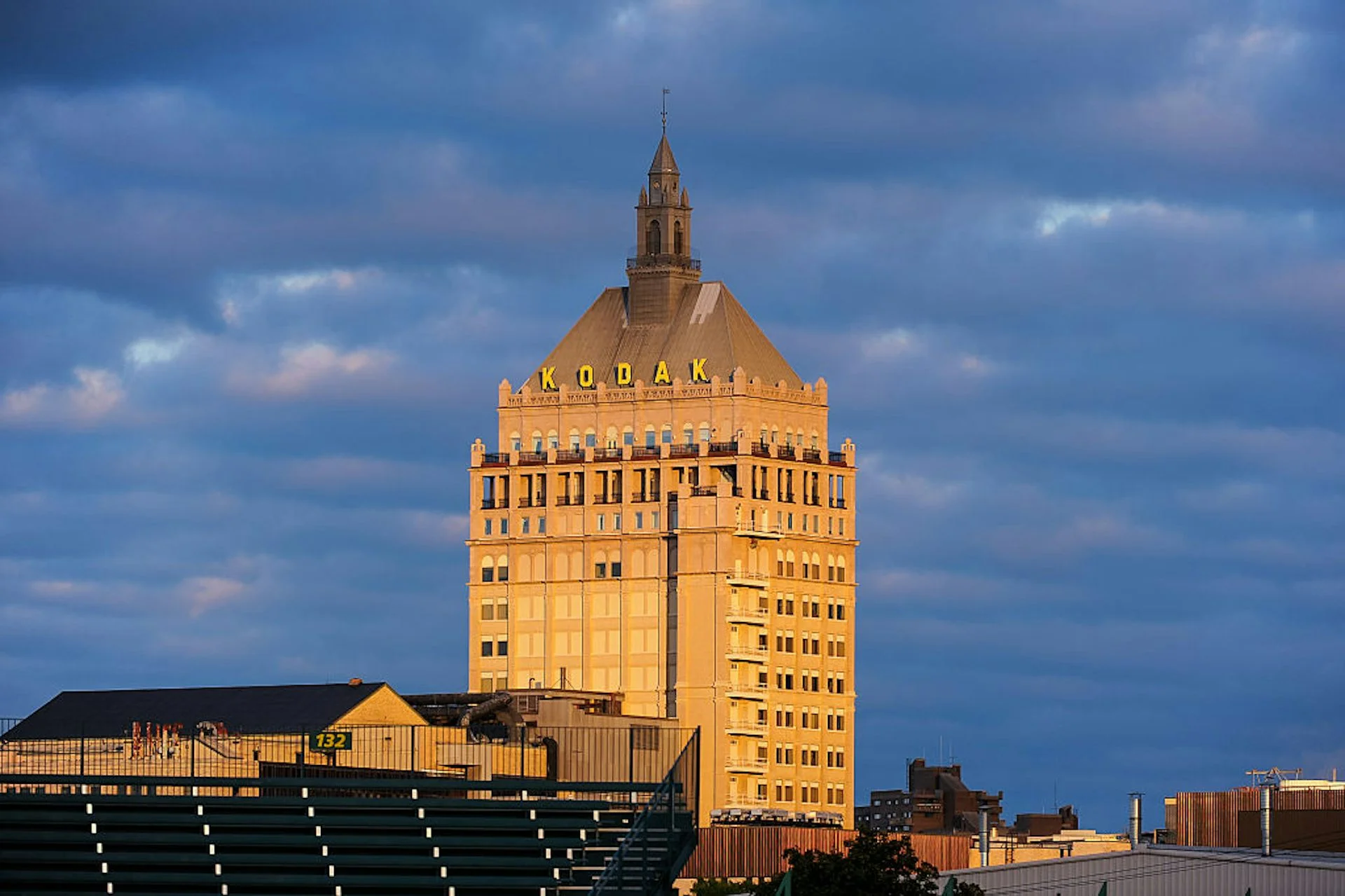A 16-story skyscraper with a spire designed in the French Renaissance style standing against a backdrop of dramatic clouds.