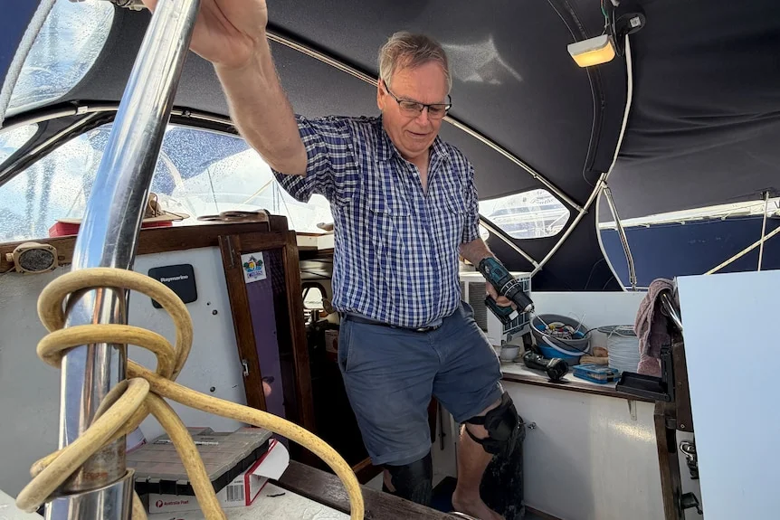 Man holding drill on a boat