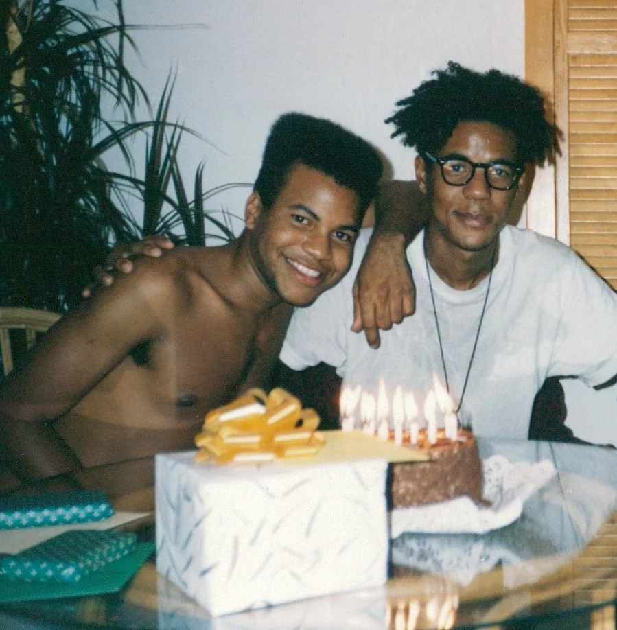 Two people with a cake and presents.