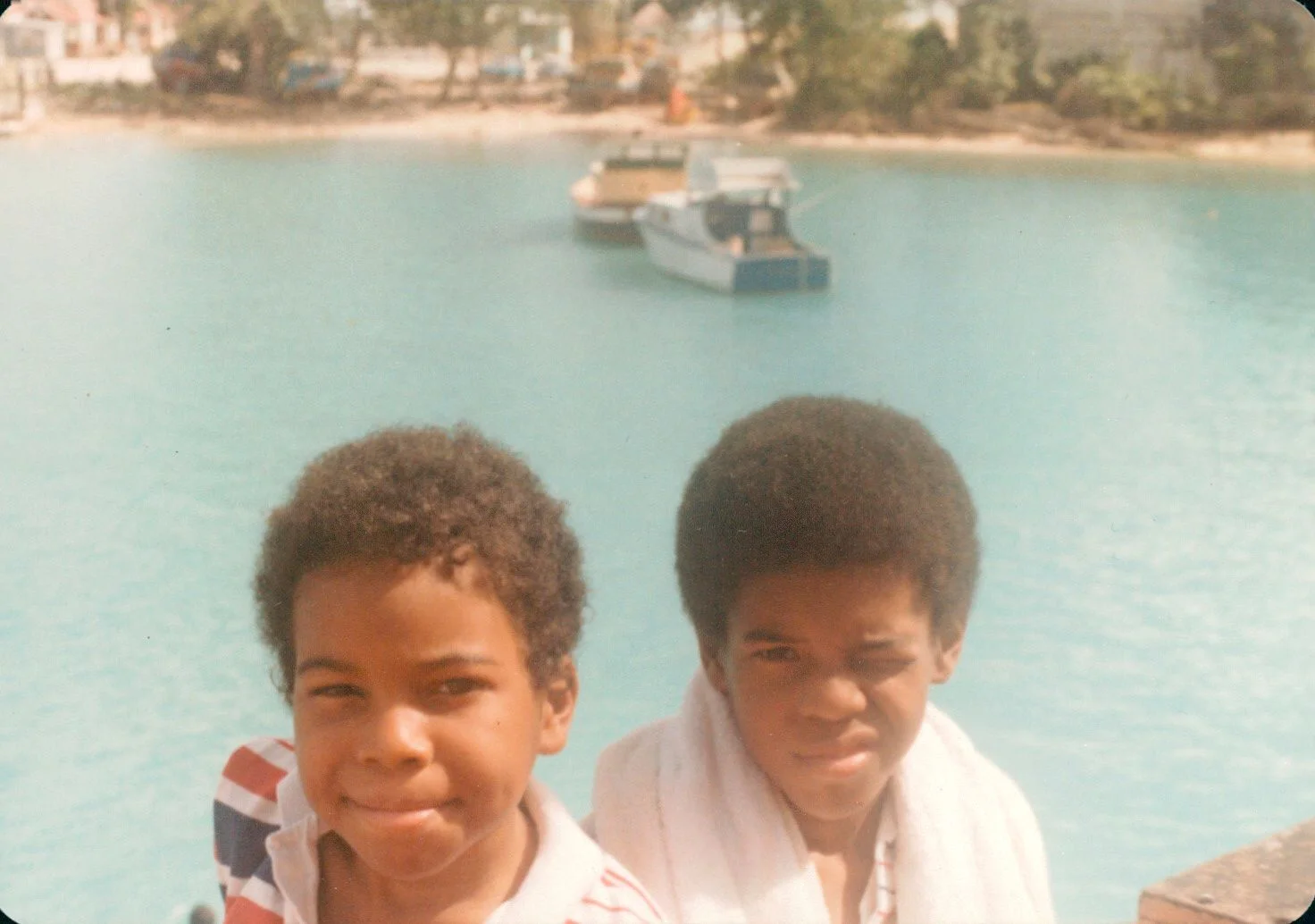 Two people in front of water.
