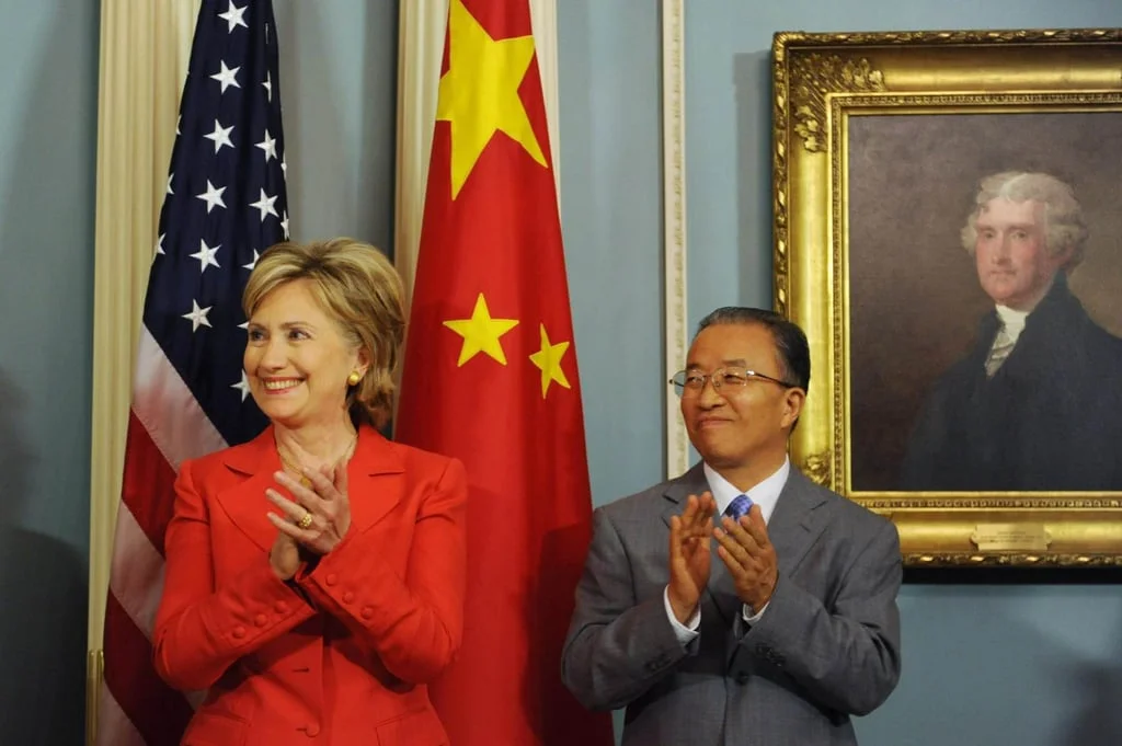 Then US secretary of state Hillary Clinton and then state councillor Dai Bingguo applaud beside a portrait of former US president Thomas Jefferson during the signing of a memorandum of understanding on clean energy and climate change in Washington on July 28, 2009. Photo: EPA