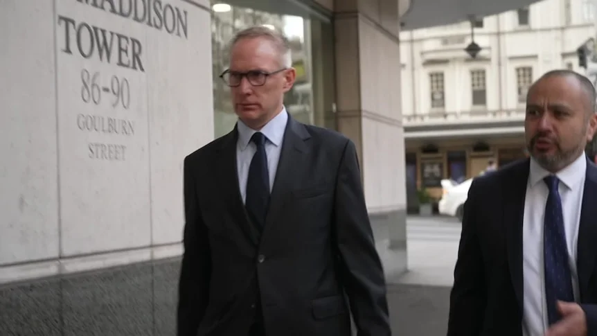 Joel Thickins and his male lawyer walk into court.
