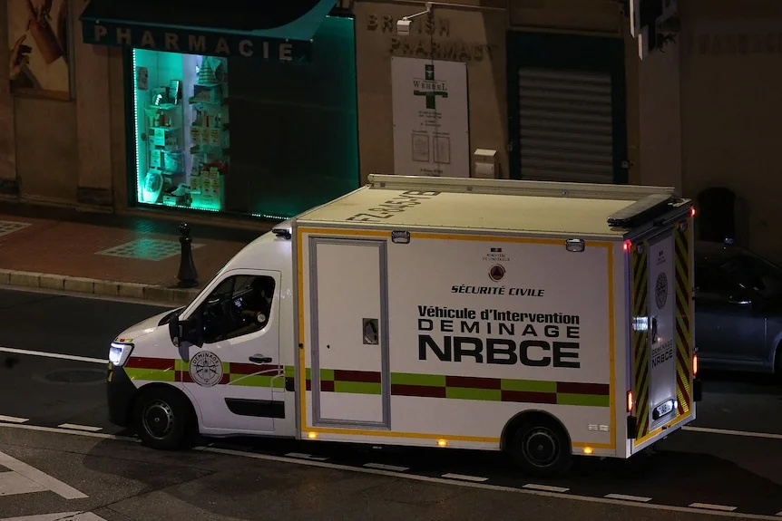 An emergency vehicle on a street at night. 