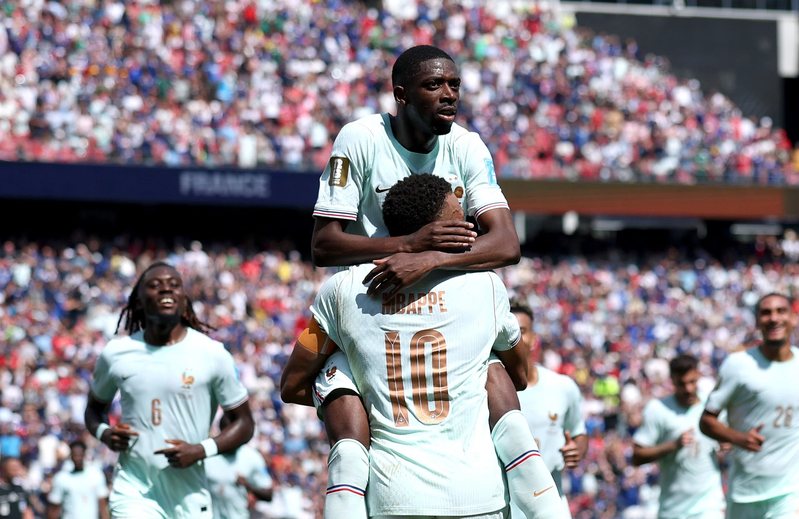 Soccer players hugging on a field.